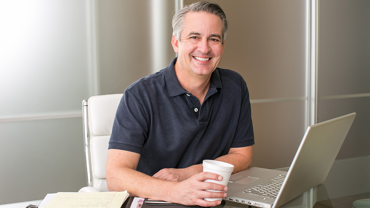 Smiling man with laptop