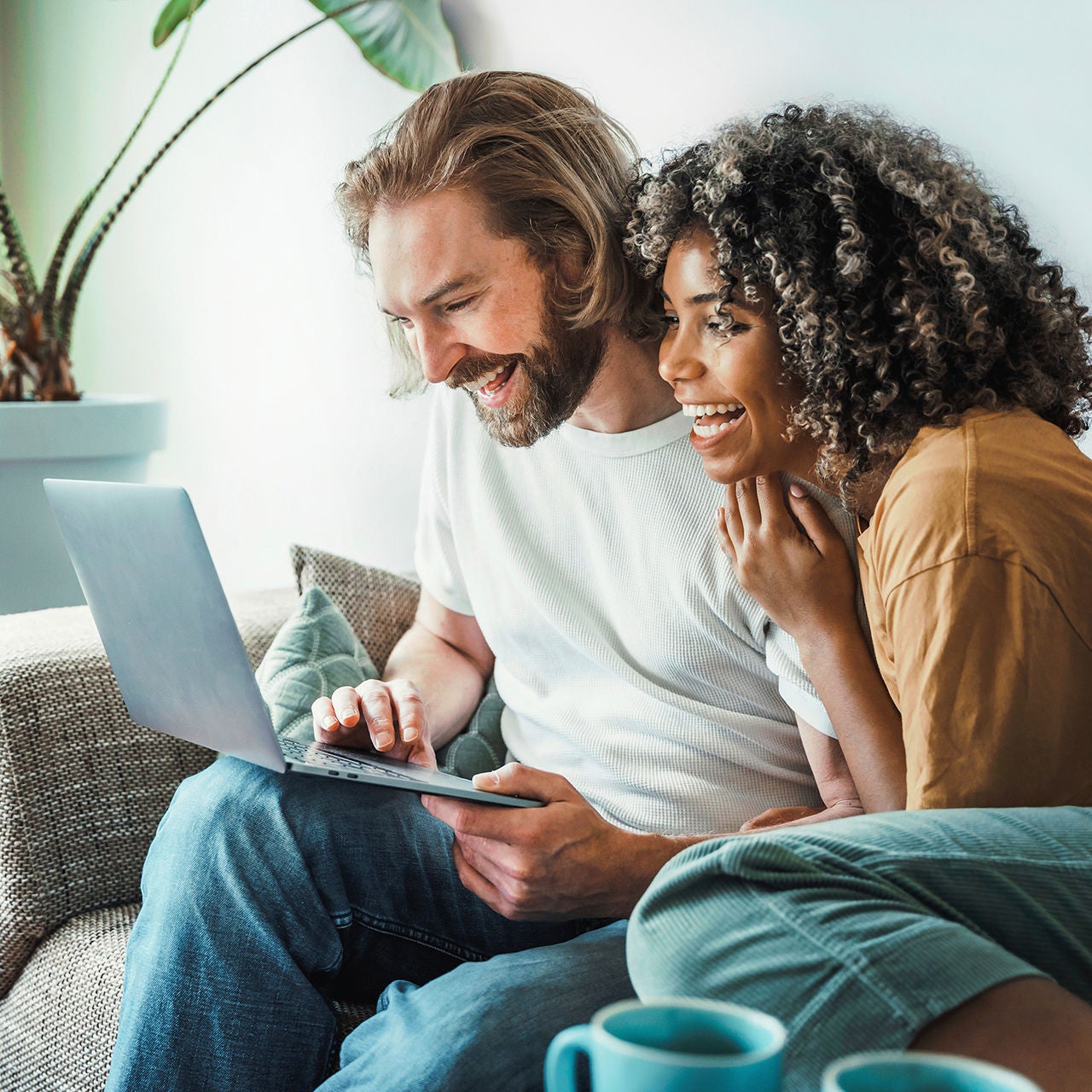 Young couple looking at laptop while smiling