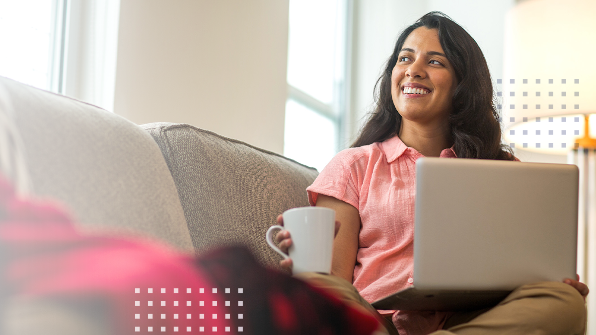 A woman smiling while using a laptop connected wirelessly to a Calix GigaPoint ONT device