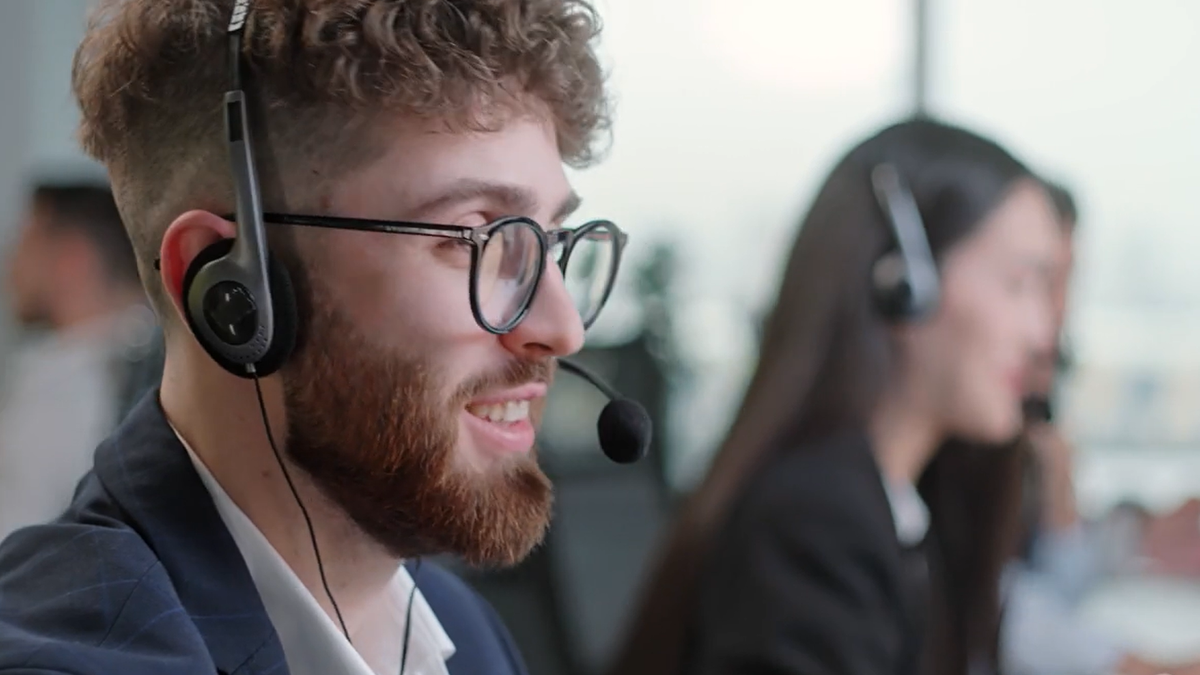 Close up customer support representative with headphone working in the office