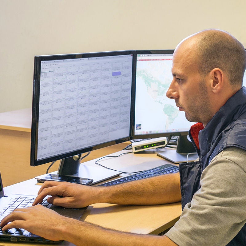 man monitoring computer screens