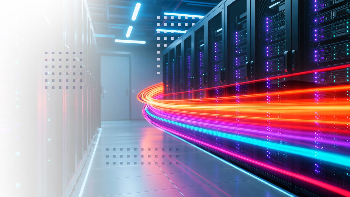 A row of black server racks lines a brightly lit data center corridor. Vivid red, orange, and blue light trails sweep through the space, symbolizing fast data transfer and advanced technology. The environment is clean and futuristic, with a cool blue palette and geometric accents. No people or visible text are present in the image.