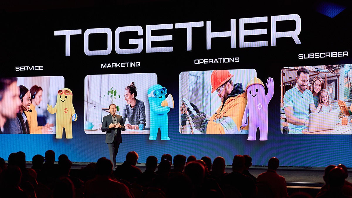 Michael Weening on Main Stage with background of AI Agents and Together message