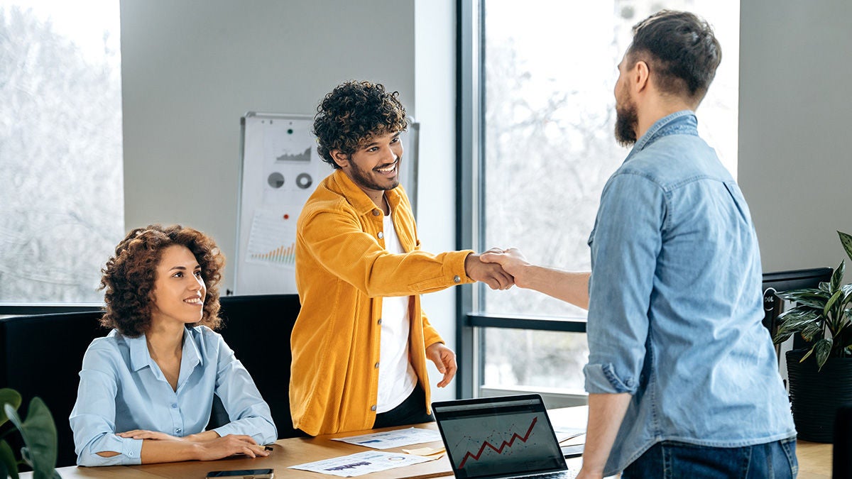 Office workers shaking hands