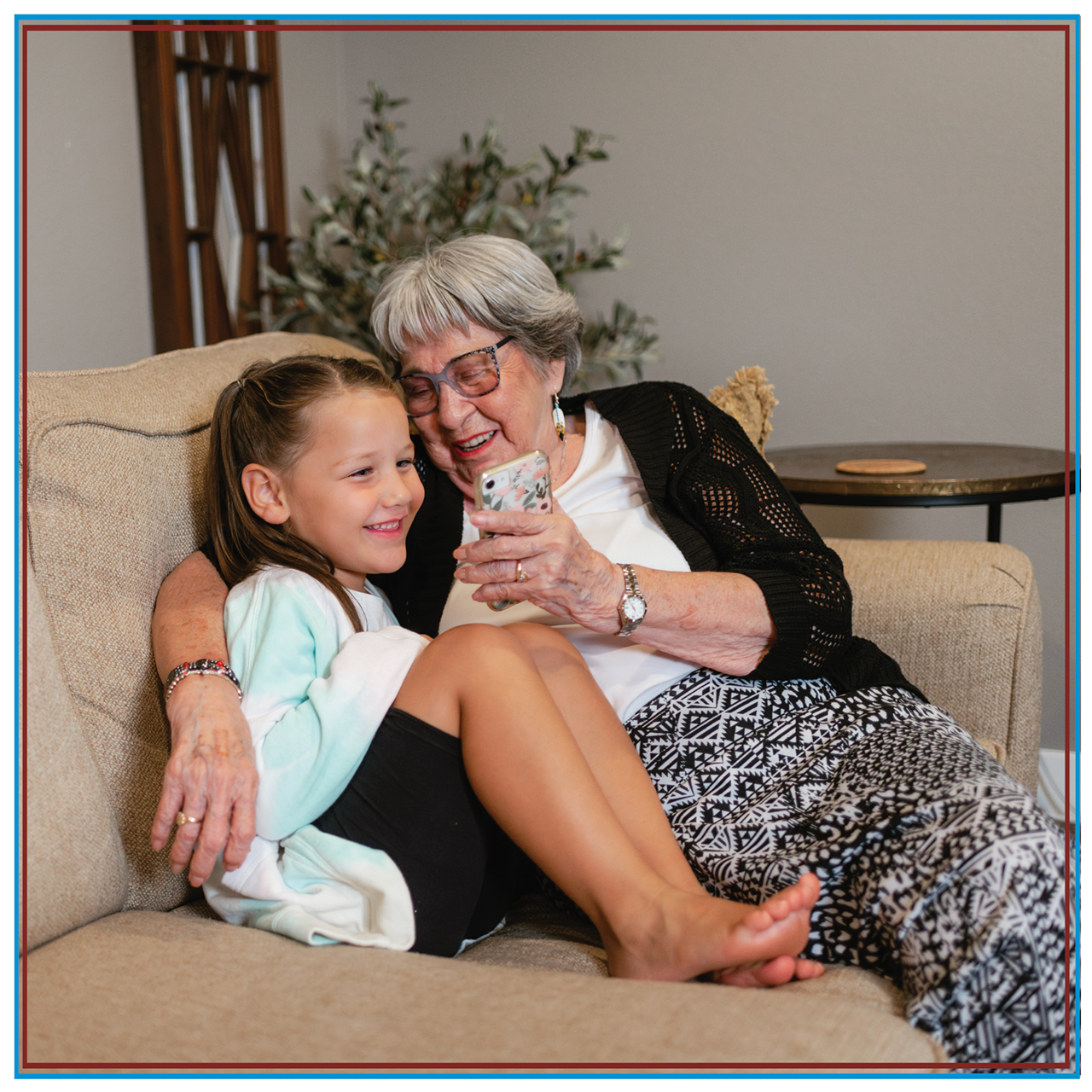 A mother and her two daughters using tribal broadband on a tablet