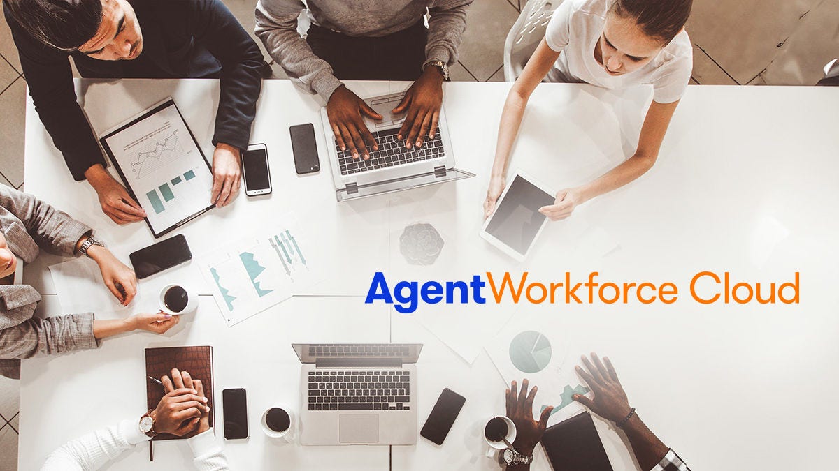 A diverse group of professionals gathers around a white table, working with laptops, tablets, and documents