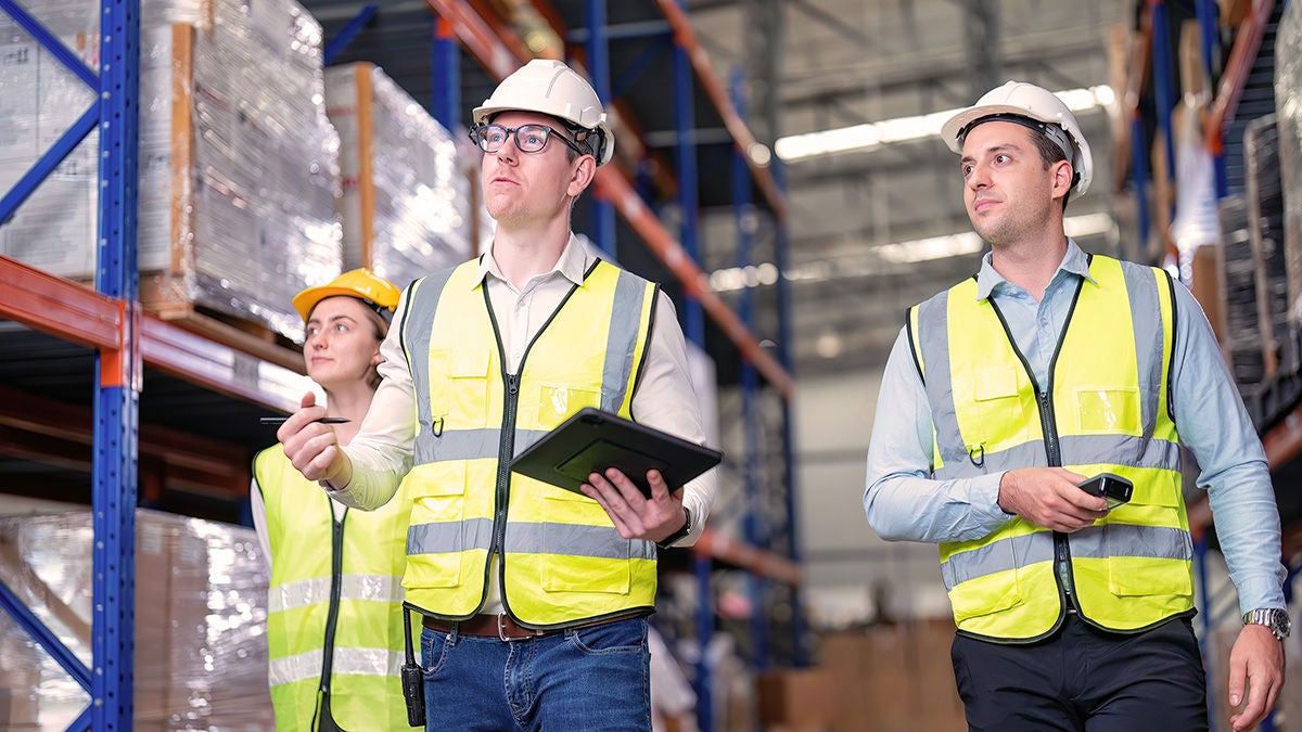 inspectors using tablet in warehouse