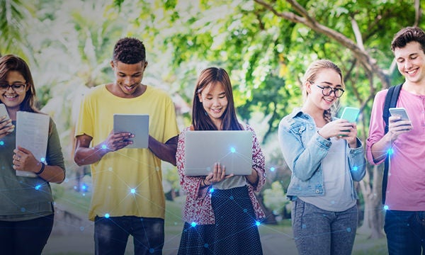 young students using mobile, laptop and tables in the university campus