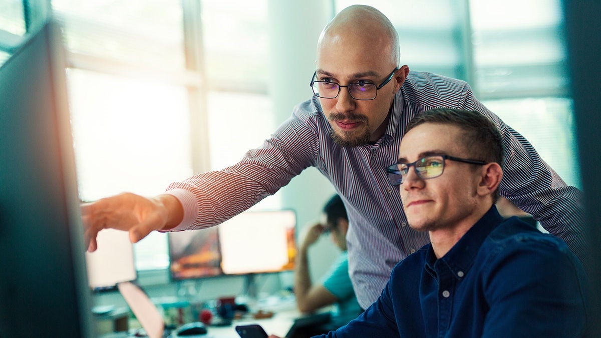 men looking and pointing at screen