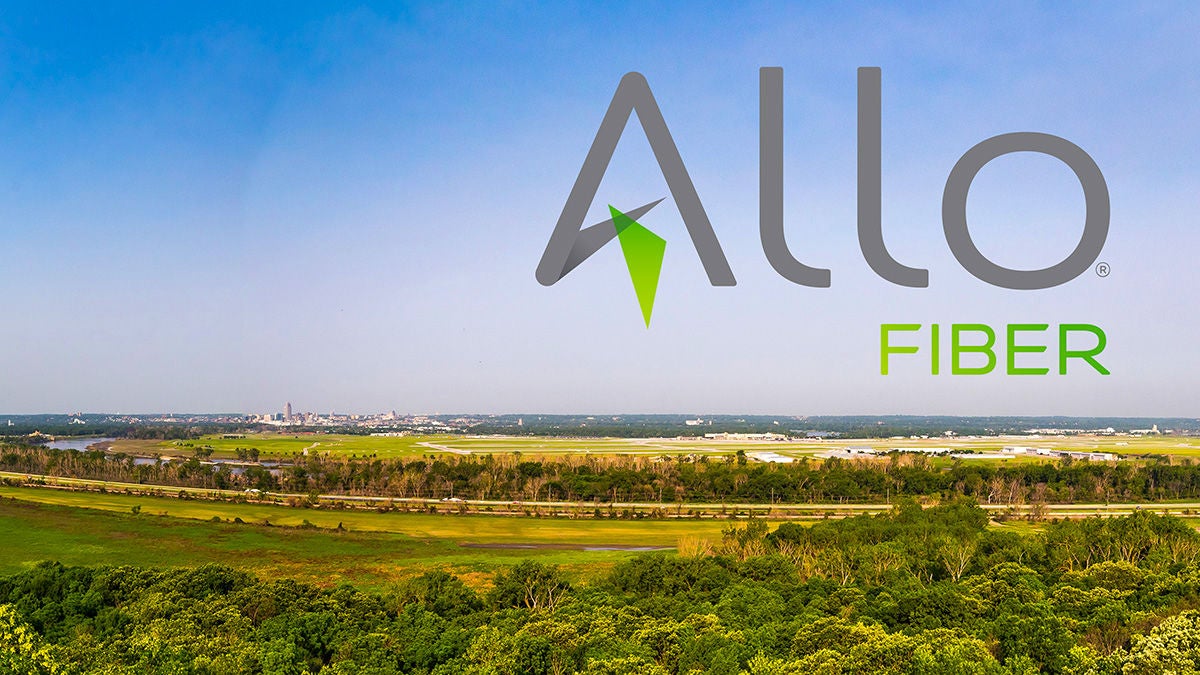 The Allo Fiber logo laid on a rural scenery with green trees