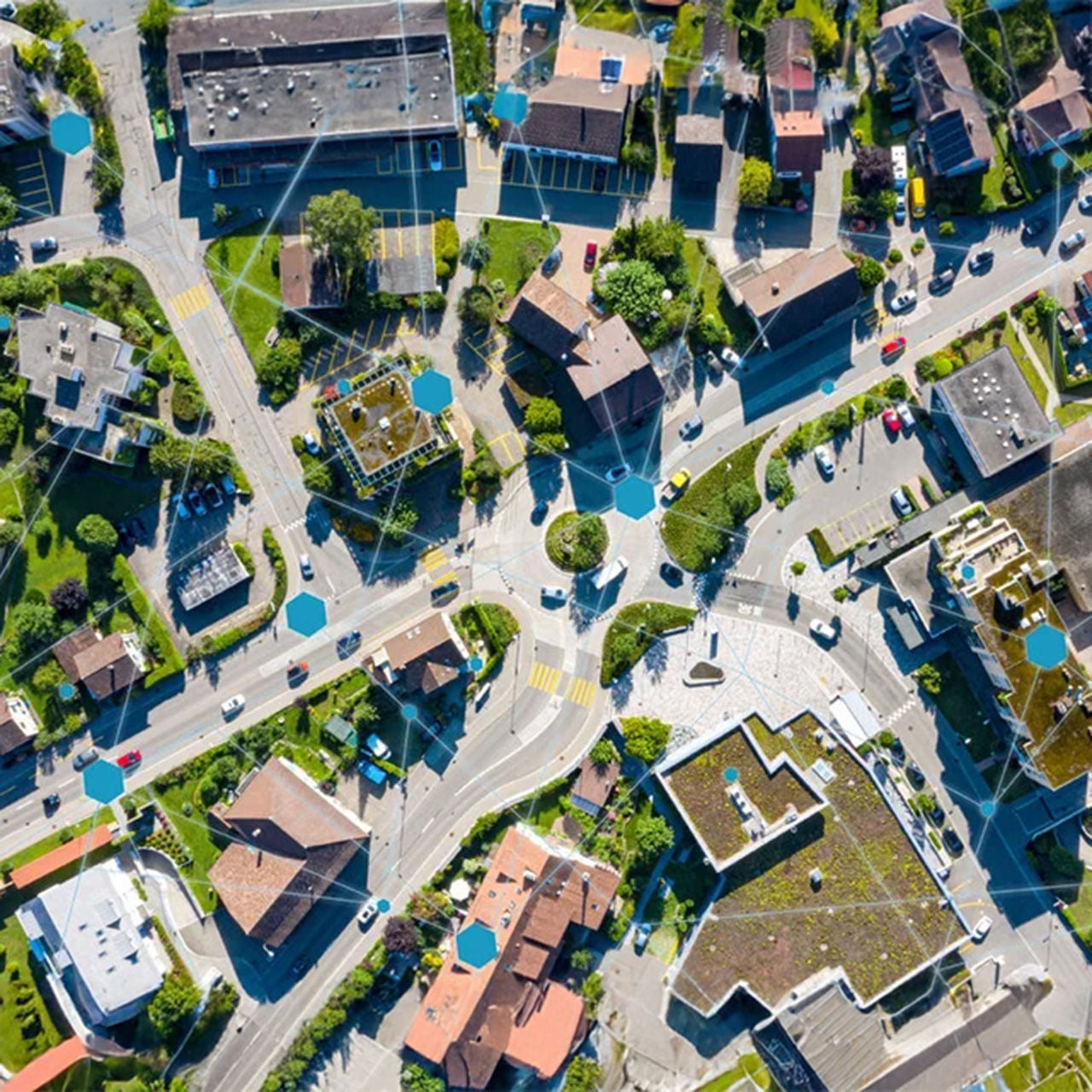 An aerial image of a small town with an abstract network icons overlay