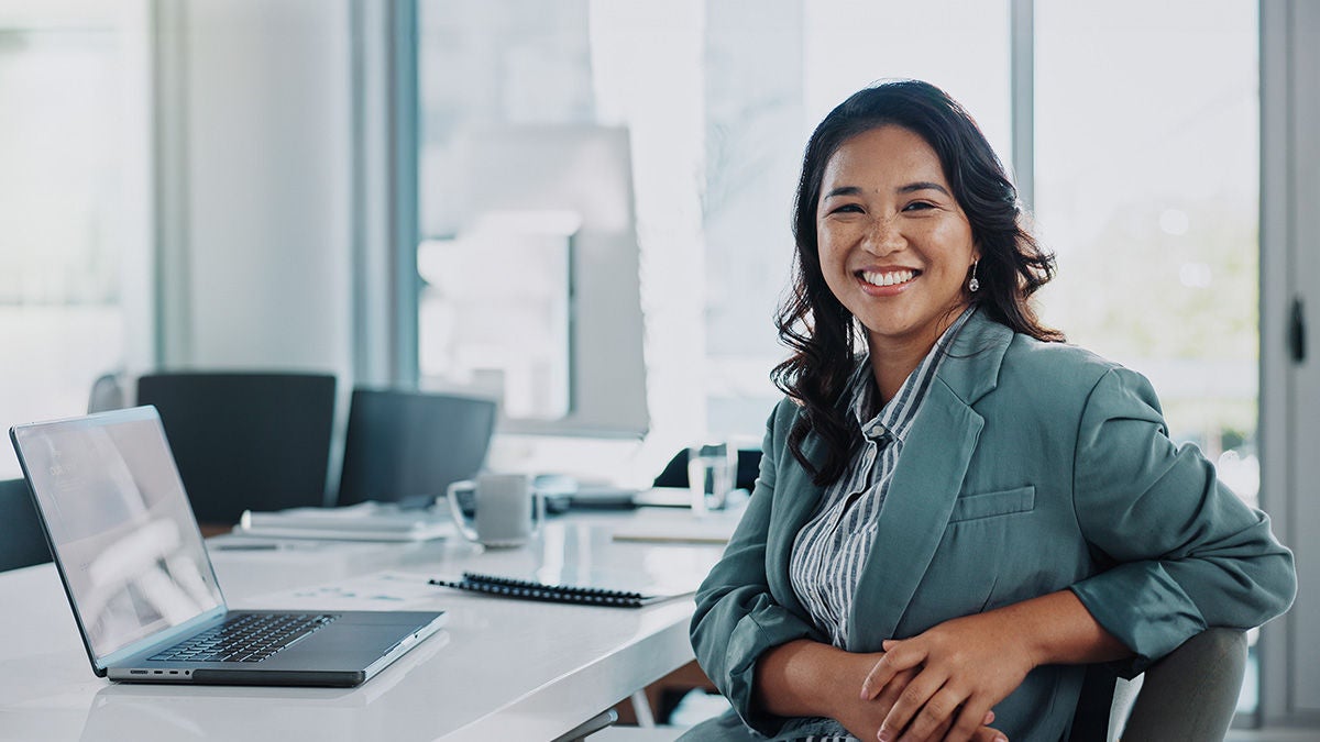 Professional woman smiling with laptop