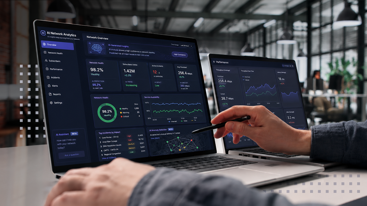 A person works at a desk with two laptops displaying a dark-themed Calix network analytics dashboard