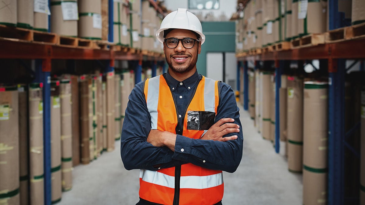 Smiling worker with safety gear