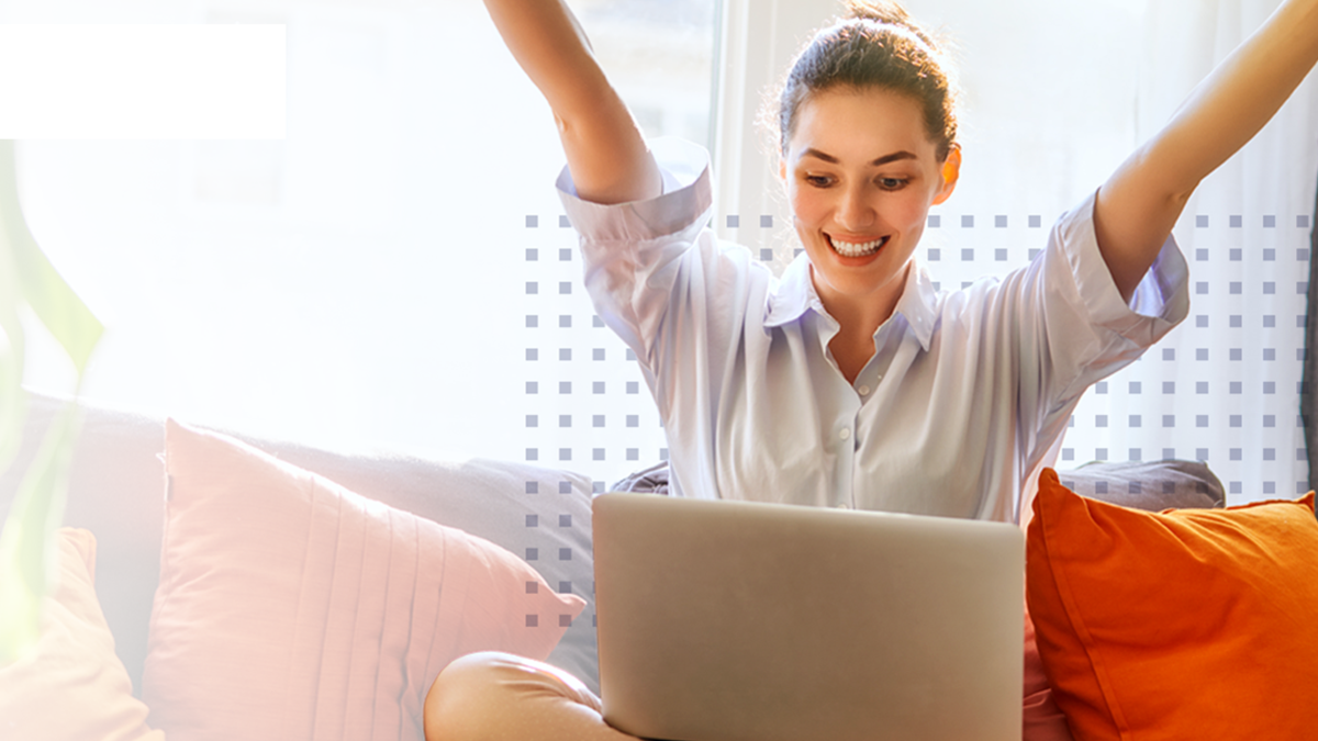 A woman cheering at her laptop from receiving service excellence