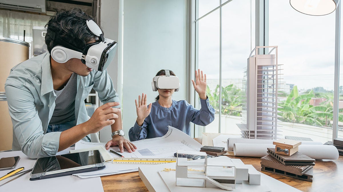 coworkers-vr-goggles-ar-architecture-rectangle Two coworkers wearing AR goggles while viewing architecture projects