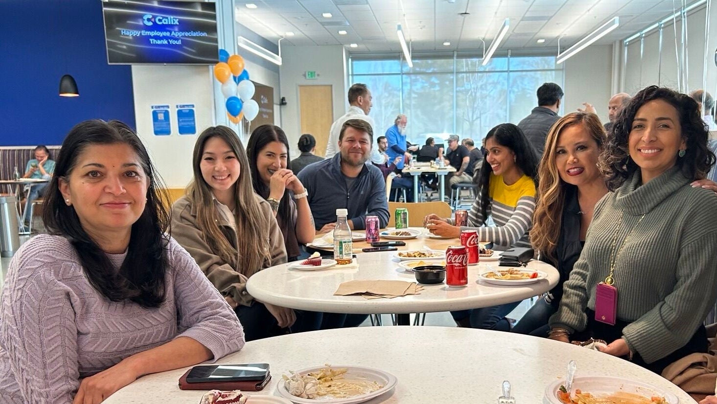 Smiling Calix employees at lunch