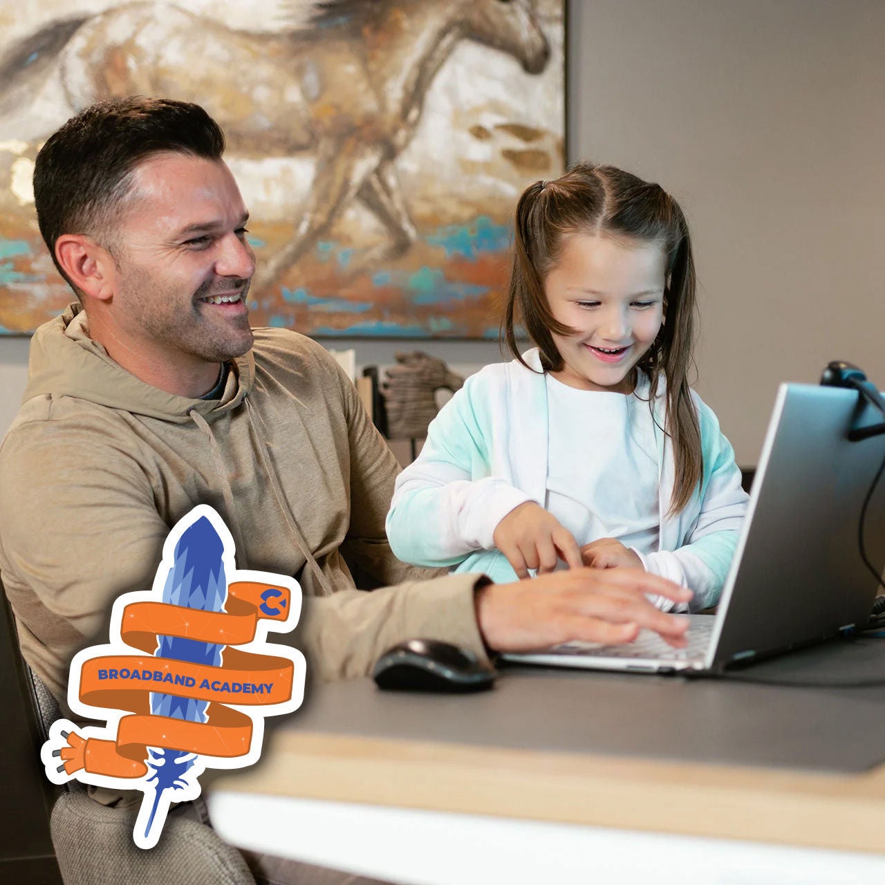 Father and daughter smiling while using a laptop