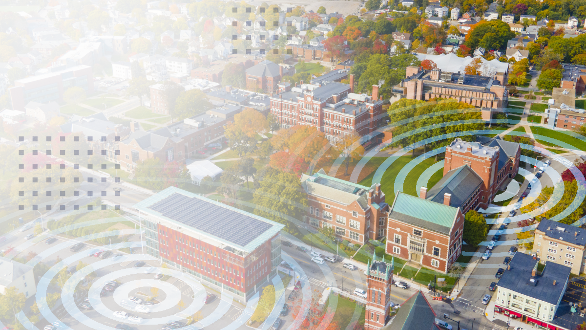 An aerial view of a small town with Wi-Fi ring icons overlaid