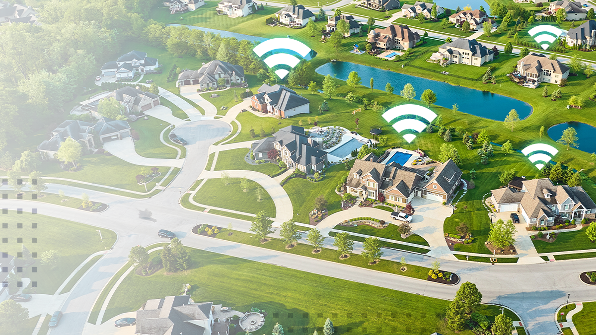An aerial image of a master-planned community with abstract Wi-Fi icons overlaid on the homes