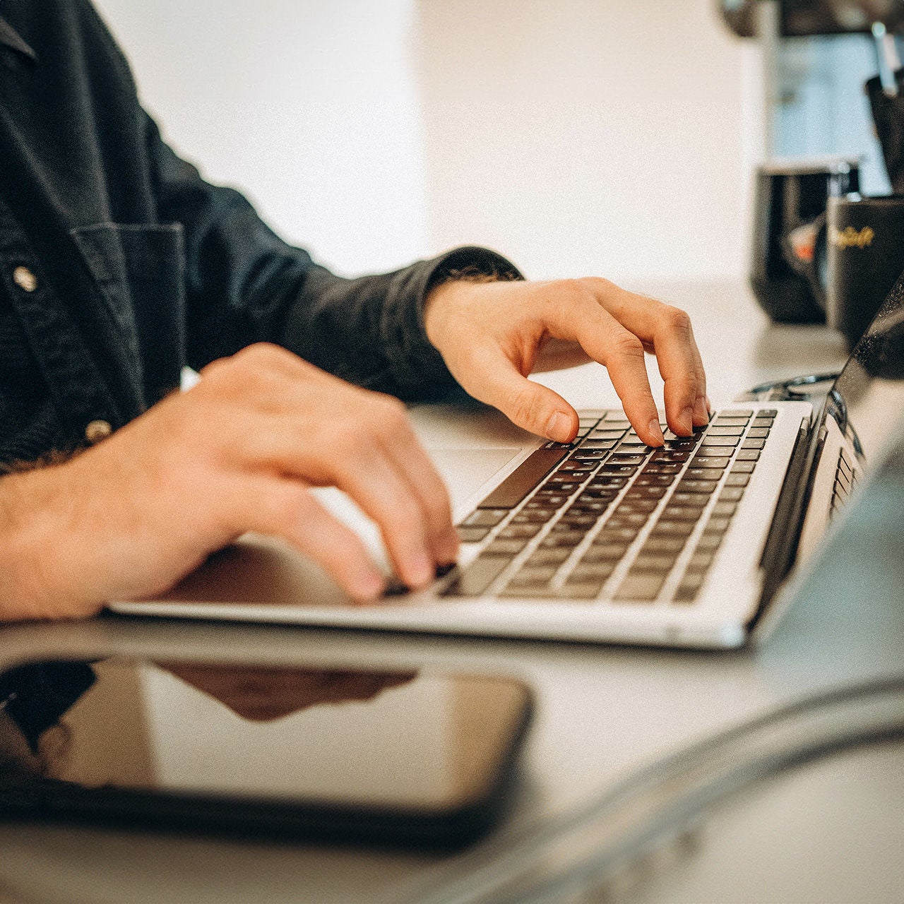 Hands on laptop keyboard