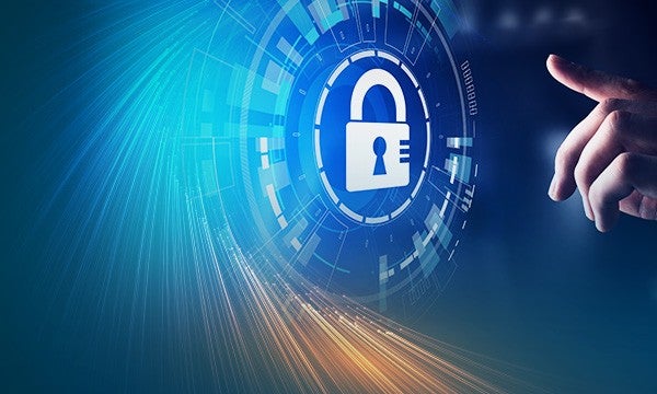 Businessman hand touching a cybersecurity shield for digital protection