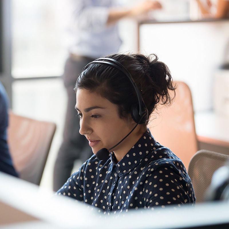 Woman with headset working at desk