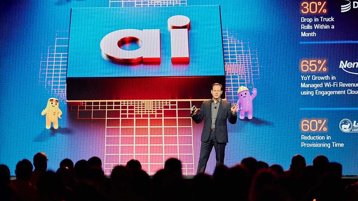 MIchael Weening on main stage with AI and Agentic AI agents on screen in background