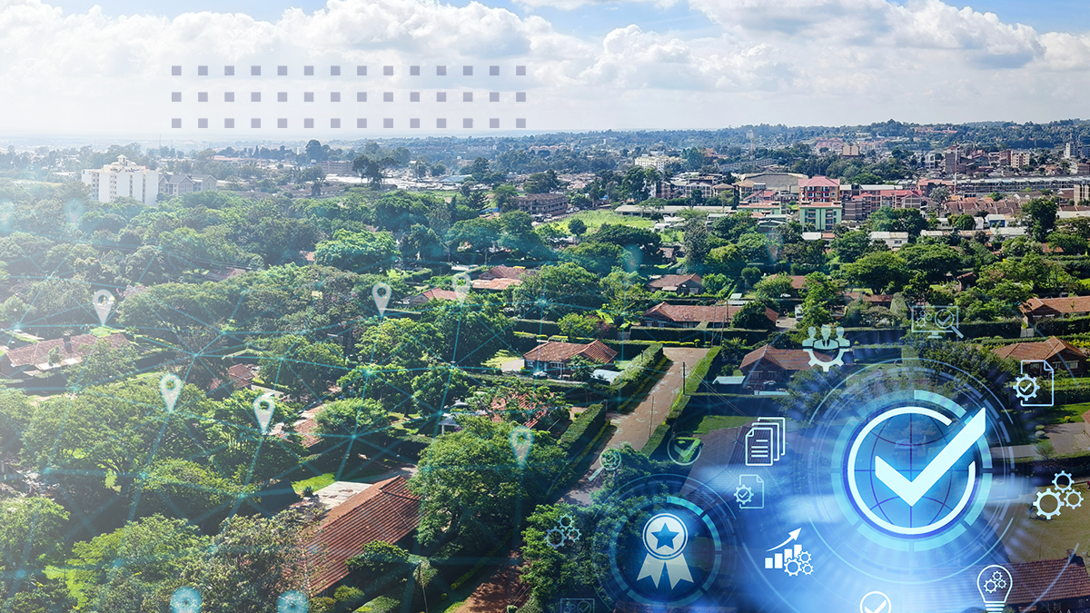 An aerial view of a small town with a blue check mark and various icons overlaid