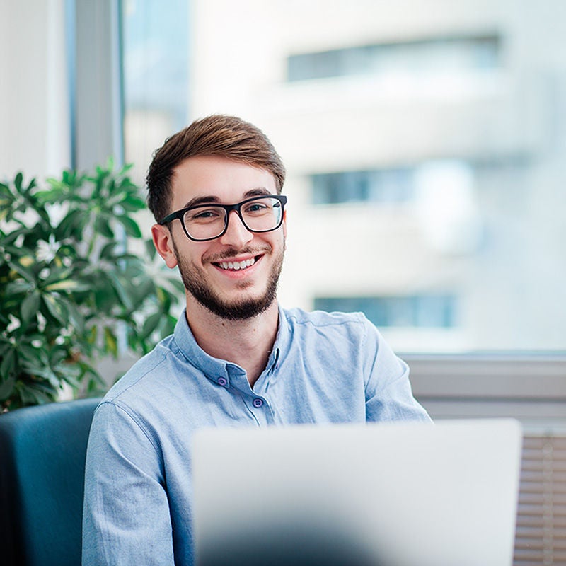 smiling professional man with computer