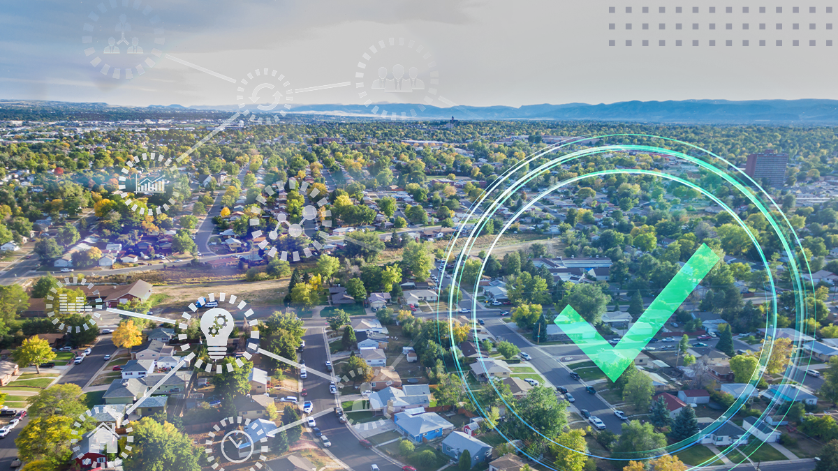 Aerial view of a town with wireless communication network icons and verified sign