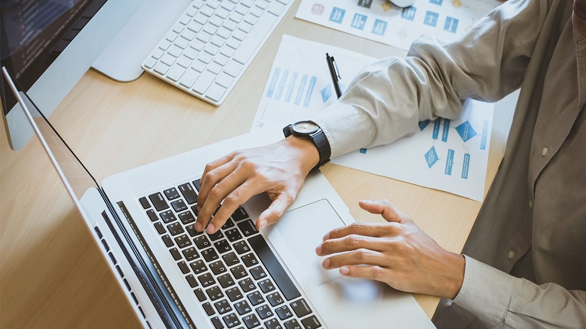 Newsletter concept Hand of businessman checking message box on digital laptop