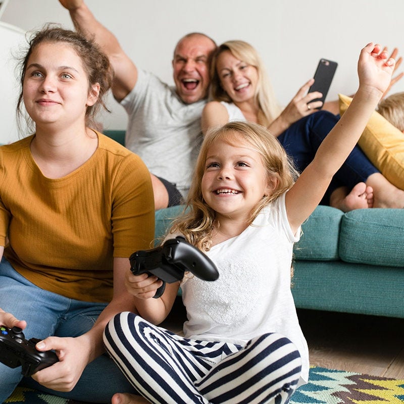 Family with devices on sofa