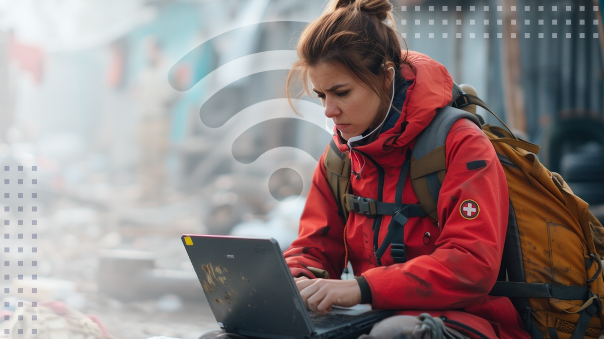 woman with headset on laptop with wi-fi on medical support disaster scene