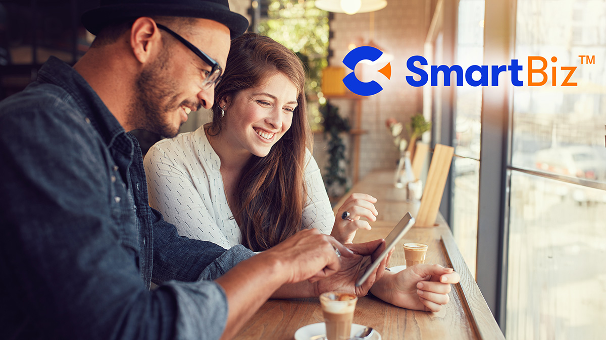 Calix SmartBiz logo over couple in coffeeshop with device