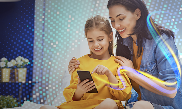 happy smiling mother and daughter use a smartphone